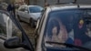 A Ukrainian woman sits in a car in Zaporizhzya with her family after they managed to flee from the Russian-occupied territory of Kherson on November 5.