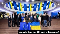 Ukraine's President Volodymyr Zelenskiy (center), Prime Minister Denys Shmyhal (right), and European Commission President Ursula von der Leyen pose for a picture with other officials before the start of a Ukraine-EU summit in Kyiv on February 2.
