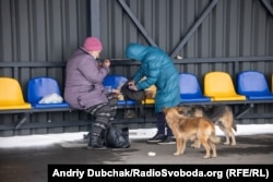 Жінки обідають на стільчиках очікування перед входом до КПВВ