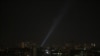 A searchlight looks for drones in the sky over Kyiv during a Russian drone strike on May 19.