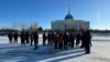 Kazakh security officers line up in Astana to block the path of protesters who wanted to head to the city's presidential office to protest the deaths of relatives killed during unrest in January 2022.