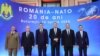 Romanian President Klaus Iohannis (third right) attends a NATO meeting with other Romanian officials.