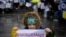 A child holds a sign saying "demobilization" in Ukrainian during a protest by soldiers' families in November 2023.
