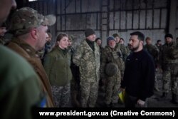 President Volodymyr Zelenskiy talks to Ukrainian soldiers near Bakhmut on March 22.