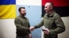 The military in the Kherson region presented President Volodymyr Zelenskiy (left) with a clock made from a damaged enemy cannon and featuring a map of Crimea on March 23.