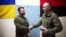 The military in the Kherson region presented President Volodymyr Zelenskiy (left) with a clock made from a damaged enemy cannon and featuring a map of Crimea on March 23.