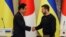 Ukrainian President Volodymyr Zelenskiy (right) greets Japanese Prime Minister Fumio Kishida in Kyiv on March 21. 