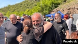 Armenia - Archbishop Bagrat Galstanian is greeted by a supporter during protests in Tavush region, April 29, 2024.