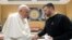 Pope Francis (left) shakes hands with Ukrainian President Volodymyr Zelenskiy at the Vatican on May 13.