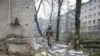 A Ukrainian soldier walks past residential buildings damaged by a Russian military strike in the frontline city of Bakhmut, Donetsk region, on April 21. 