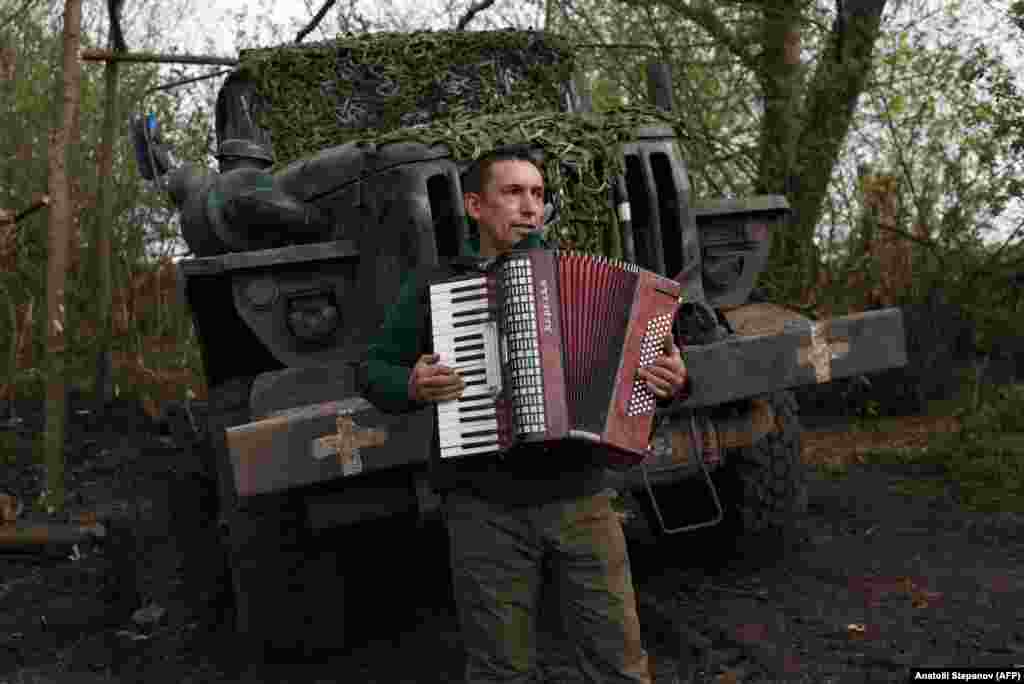 ...while another relaxes by playing an accordion.