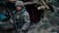 A Ukrainian soldier in a trench close to Russian positions near Kremenna in the Luhansk region on May 9.