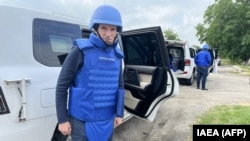 IAEA head Rafael Grossi stands next to his car at an undisclosed location in Ukraine on his way to visit the Zaporizhzhya nuclear power plant in Enerhnodar, Zaporizhzhya region, on June 15. 