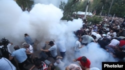 Armenia- Protesters are hit by stun grenades thrown by police during a demonstration near the Armenian parliament, June 12, 2024.