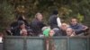 ARMENIA - Refugees from Nagorno-Karabakh ride in the back of a truck as they arrive in the border village of Kornidzor, September 26, 2023.