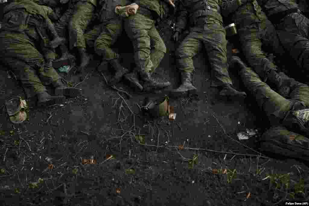 The bodies of 11 Russian soldiers lie on the ground in the village of Vilkhyvka, recently retaken by Ukrainian forces near Kharkiv, on May 9, 2022.