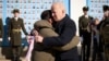 U.S. President Joe Biden (right) embraces his Ukrainian counterpart, Volodymyr Zelenskiy, as they visit the Wall of Remembrance to pay tribute to slain Ukrainian soldiers, in Kyiv on February 20.