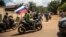 Supporters of a coup in Burkina Faso wave a Russian flag in October 222.