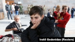 ARMENIA - A refugee boy from Nagorno-Karabakh waits upon his arrival at a temporary accommodation center in Goris, September 25, 2023.