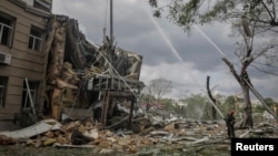 Rescuers work at the site of a building heavily damaged by a Russian missile attack in central Odesa, Ukraine, on July 20.