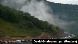 Vehicles carrying refugees from Nagorno-Karabakh queue on the road leading towards the Armenian border, September 25, 2023.