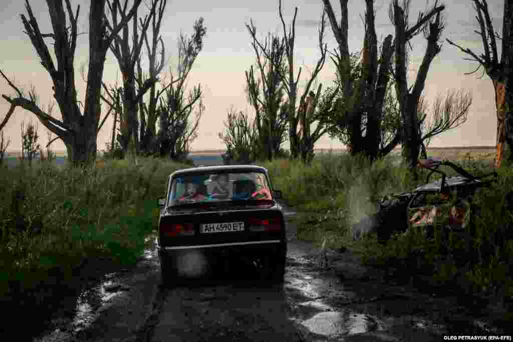 Харьков облусунун Довенькое кыштагынын 41 жаштагы тургуну Микола үй-бүлөсүн алып кетип баратат. Анын коңшу Краснополье кыштагындагы үйү орус армиясынын соккусунда тыптыйпыл болуп кыйрап калган.&nbsp;(EPA-EFE/OLEG PETRASYUK)