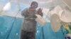 A Kazakh voter takes part in the parliamentary elections in Almaty on March 19.