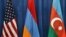 U.S., Armenian and Azerbaijani flags are displayed during peace talks.