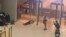 In this image grab taken from video footage, armed gunmen move past bodies of victims toward the doors of the Crocus City Hall in Krasnogorsk, outside Moscow, on March 22. At least 140 people were killed in the attack. 