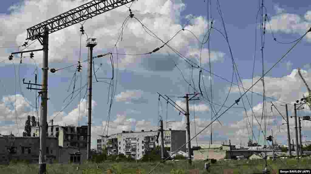 Heavily damaged residential buildings are seen in the background of a destroyed railway hub in Lyman. Formerly the home of over 20,000 people, the town has endured months of occupation and a brutal battle to liberate it in October, leaving the city nearly destroyed. &nbsp;