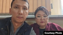 Civil activist Abzal Dostiyarov and lawyer Zhanar Balgabaeva at a police station in Almaty on September 22.