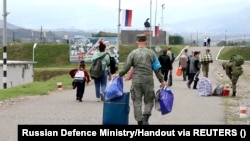 Nagorno-Karabakh - Russian peacekeepers evacuate civilians to their headquarters following Azerbaijani armed forces' offensive operation, September 21, 2023.