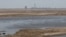 The view of the Russian-occupied Zaporizhzhya nuclear power plant from the Nikopol embankment across the Dnieper River reservoir, which is almost completely dried up following a dam breach downstream.