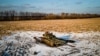 A destroyed Russian tank sits in a snow-covered wheat field in Ukraine's Kharkiv region on February 22.