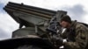 A Ukrainian paratrooper aims a Grad missile launcher at Russian positions near the front line in eastern Ukraine. 