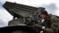 A Ukrainian paratrooper aims a Grad missile launcher at Russian positions near the front line in eastern Ukraine. 