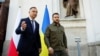Polish President Andrzej Duda (left) and Ukrainian President Volodymyr Zelenskiy talk after a church service in Lutsk on July 9.