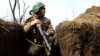 A Ukrainian soldier scouts for enemy positions from a trench in Ukraine's east. (file photo)