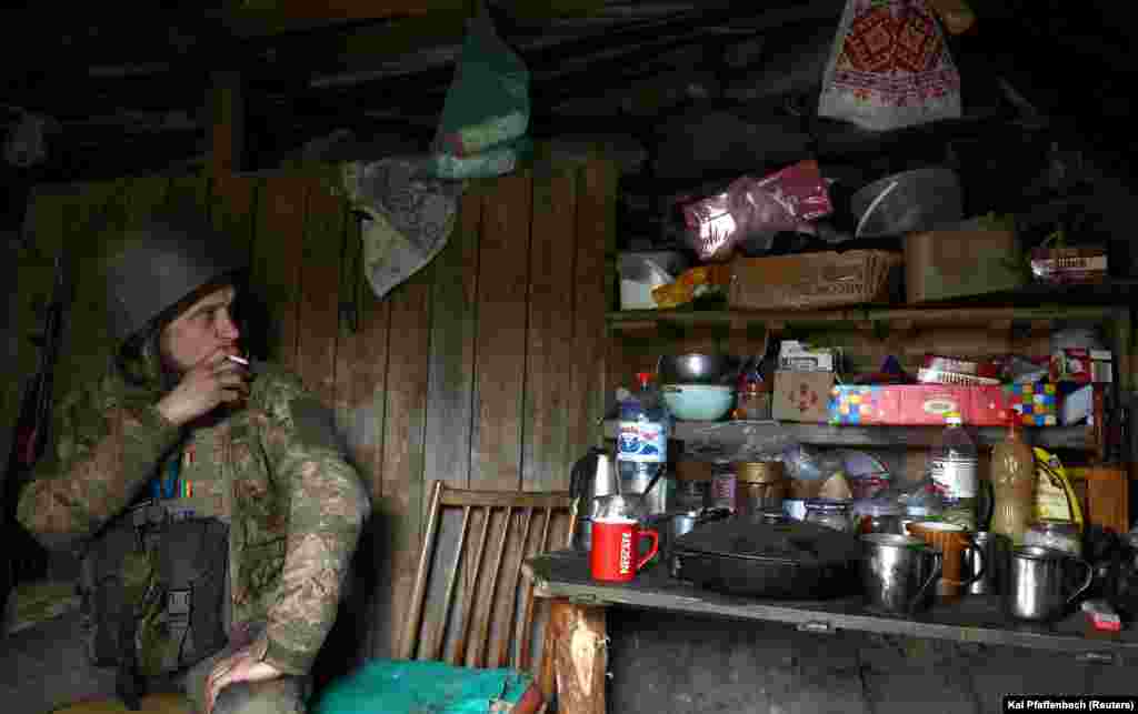 While another takes a cigarette break in his shelter.