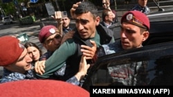 ARMENIA - Police detain a demonstrator who attempted to block a street in a protest against land transfer to Azerbaijan, Yerevan, May 13, 2024.