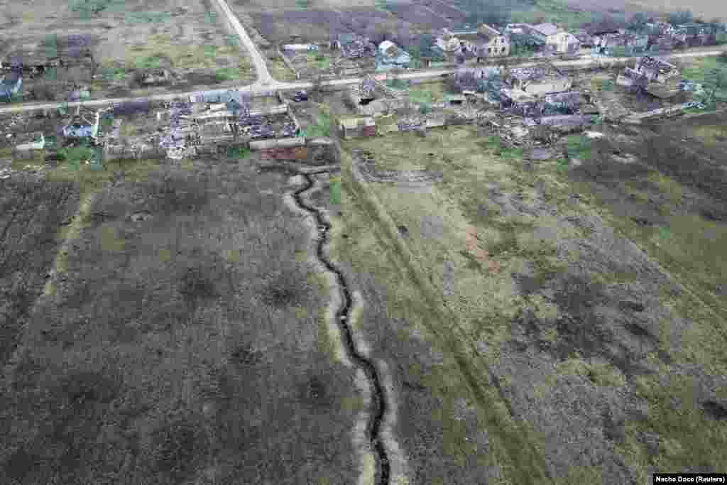 Trenches snake through the ground behind the house of 80-year-old Stepan Kovalyov and his 79-year-old wife, Tetyana, in the village of Posad-Pokrovske, which is about 36 kilometers northwest of the city of Kherson in southern Ukraine. The village was captured by Russian forces during the invasion on February 25, 2022, the day after Moscow launched what it describes as a &quot;special military operation.&quot; &nbsp;
