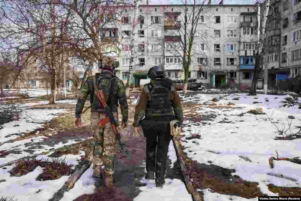 A Ukrainian soldier guides a volunteer through the shattered landscape of Chasiv Yar in hopes of persuading the last holdouts to evacuate. It is estimated that 1,500 residents remain, most of whom spend their days hiding in basements with no electricity or running water.
