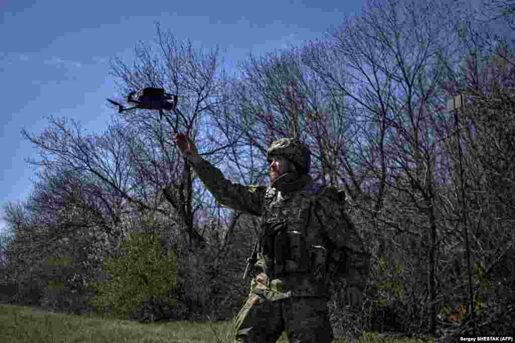 A Ukrainian soldier uses a drone to locate Russian positions near Bakhmut on April 16.
