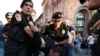 Police officers detain a protester near central government offices in Yerevan. August 8, 2023