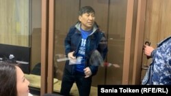 Marat Zhylanbaev appears in court in Astana on October 30.
