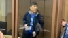 Marat Zhylanbaev appears in court in Astana on October 30.
