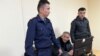 Kazakh activist Amangeldi Orazbaev (center) in court earlier this year. 