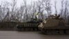Ukrainian servicemen drive armored vehicles near the frontline city of Bakhmut in the Donetsk region. 
