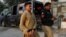 An Afghan national who according to police was undocumented is seen with his hands tied after he was detained and shifted to a holding center in Karachi, Pakistan, on November 1.