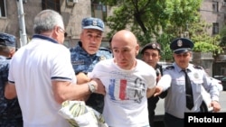 Armenia - Police detain a protester in Yerevan, April 25, 2024.